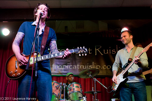 The Bolaji Blues Band on stage. Dave Lowrance (vocals), Dan Smith (guitar) & Steve Denton (drums)