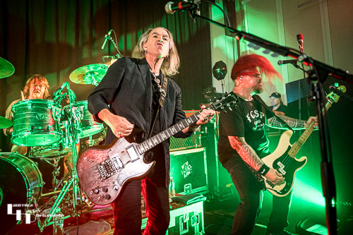 Michael Dean on drums , Justin Sullivan on vocals & guitar, Ceri Monger on bass